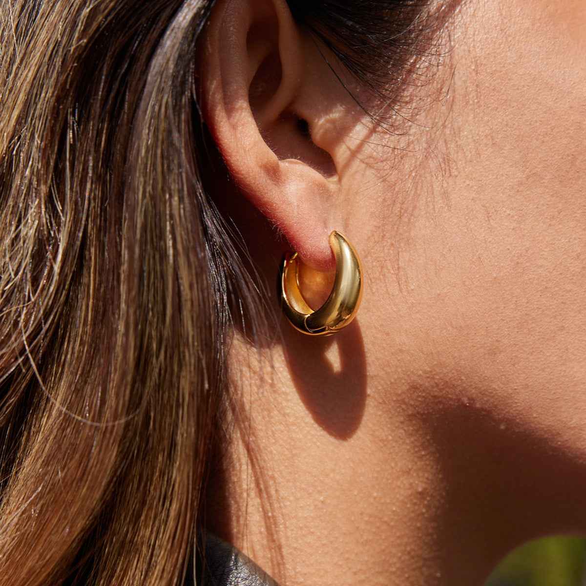 18K gold lightweight luxury earrings with engraved lettering on the inner surface.