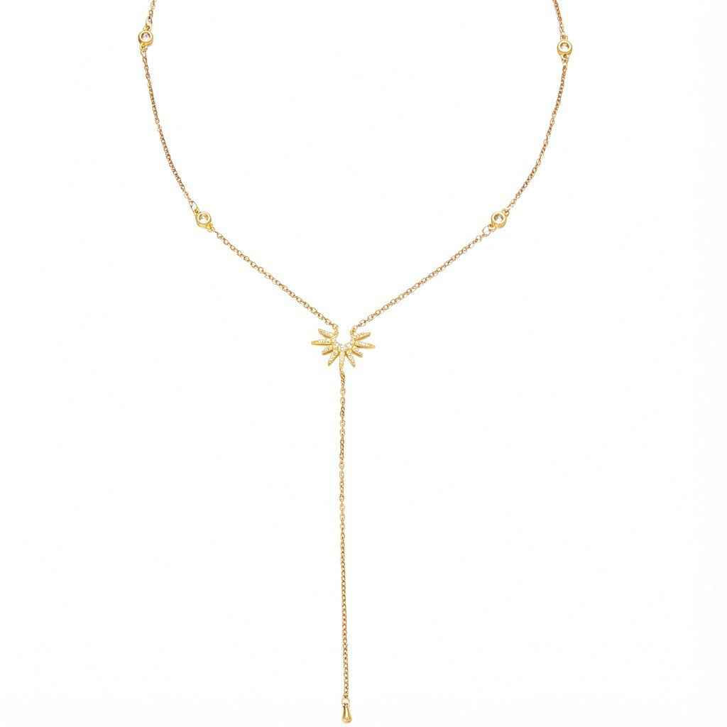 18K gold Y-shaped lasso necklace with diamond-encrusted sunflower and snowflake pendant.