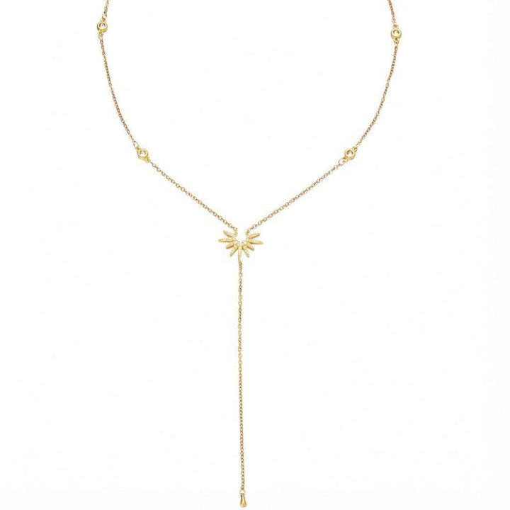 18K gold Y-shaped lasso necklace with diamond-encrusted sunflower and snowflake pendant.