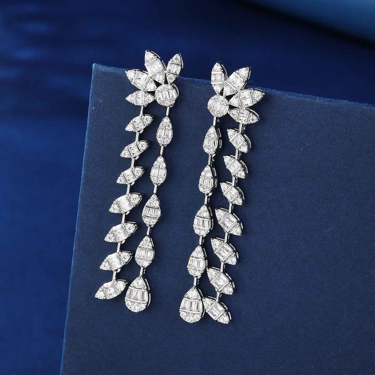 Floral design, fully encrusted with diamonds, double chain leaf earrings.