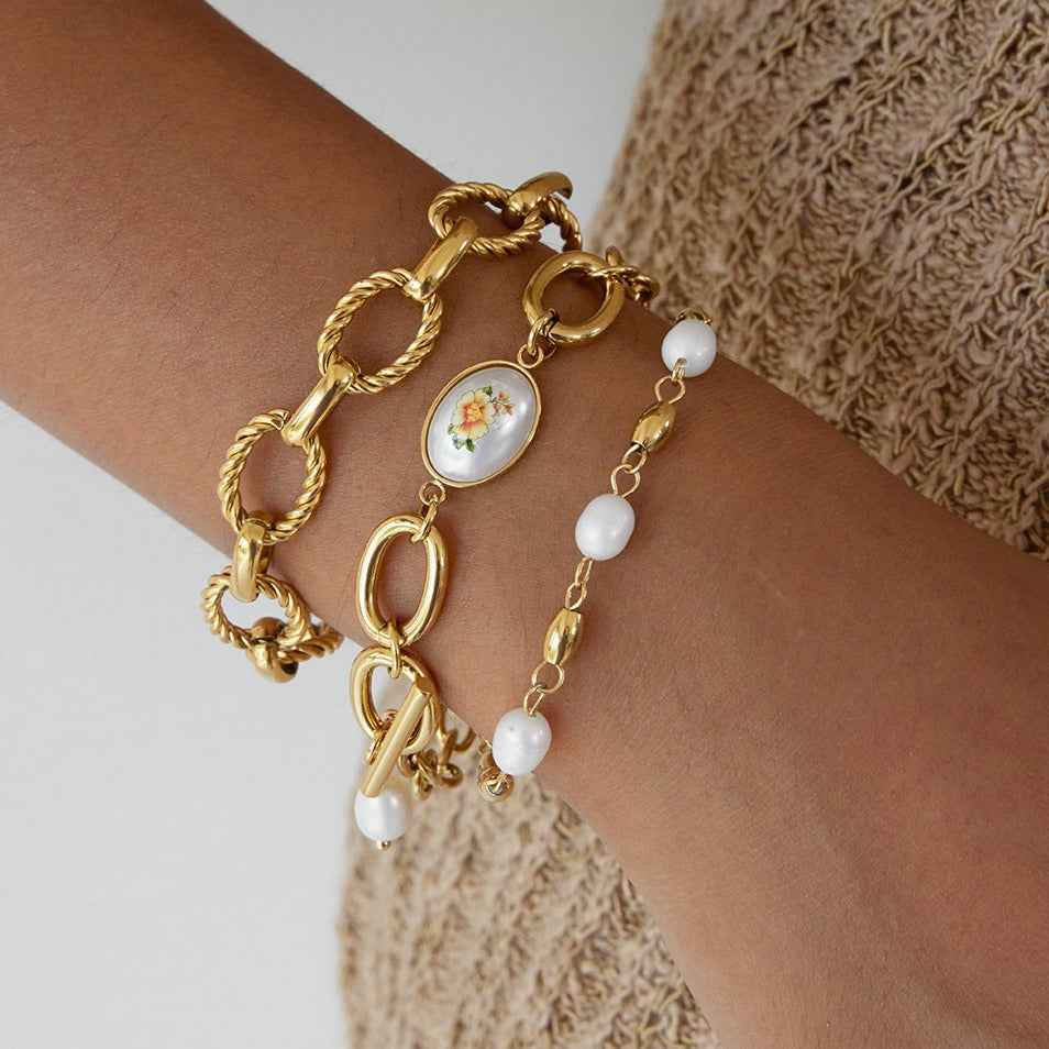 18K gold-plated, lightweight, and luxurious titanium steel bracelet with freshwater pearls.