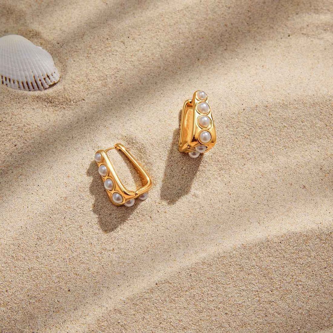 18K gold lightweight luxury earrings with embedded pearls.