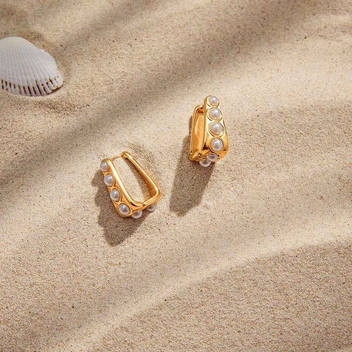 18K gold lightweight luxury earrings with embedded pearls.