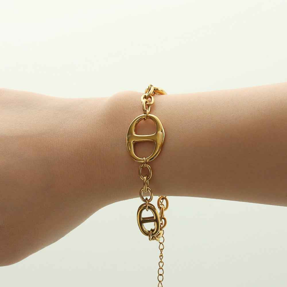 18K gold geometric-shaped necklace, bracelet, and earrings set.