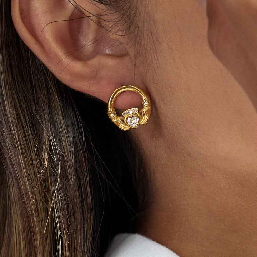 18K gold-plated friendship hand design titanium steel stud earrings with cubic zirconia.