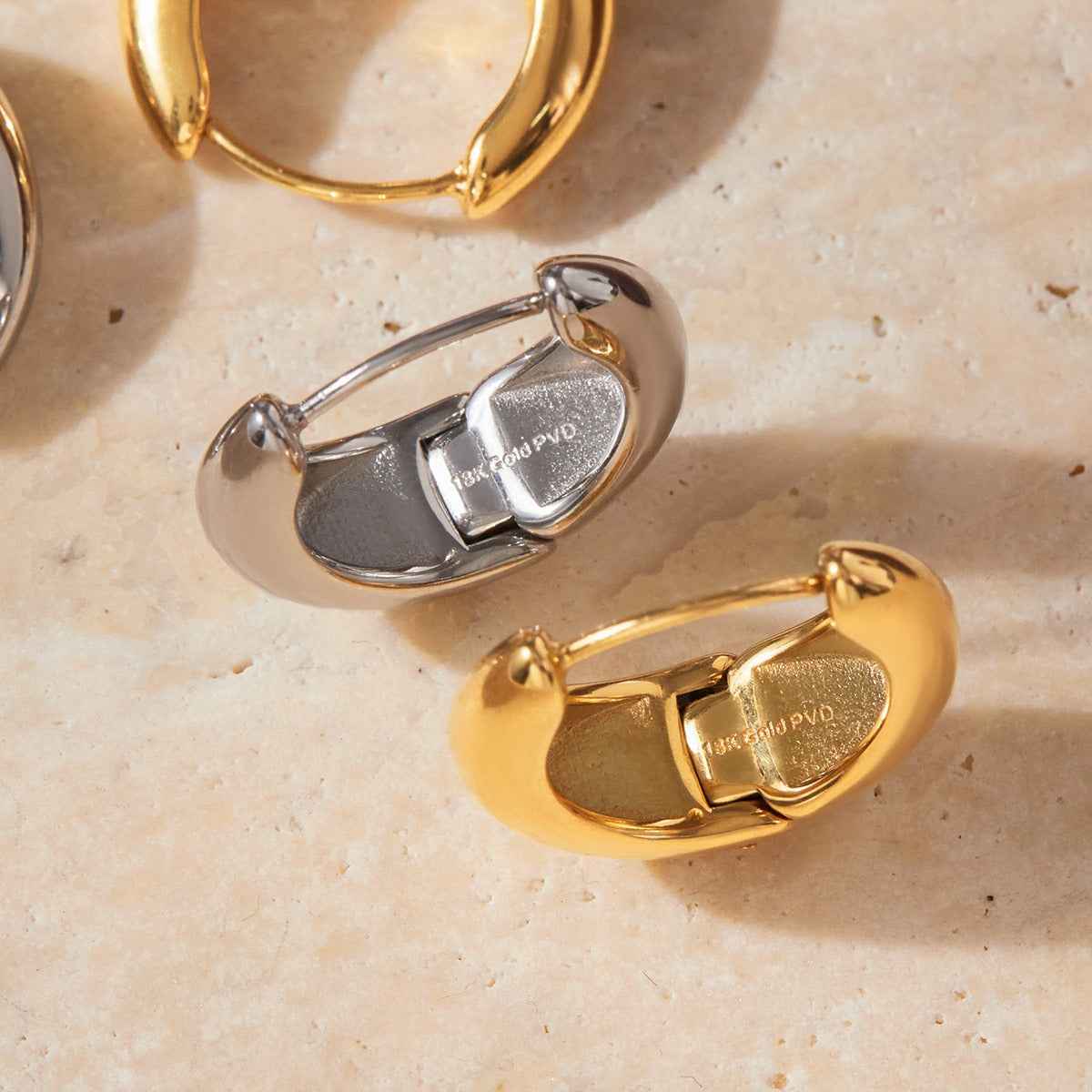 18K gold lightweight luxury earrings with engraved lettering on the inner surface.