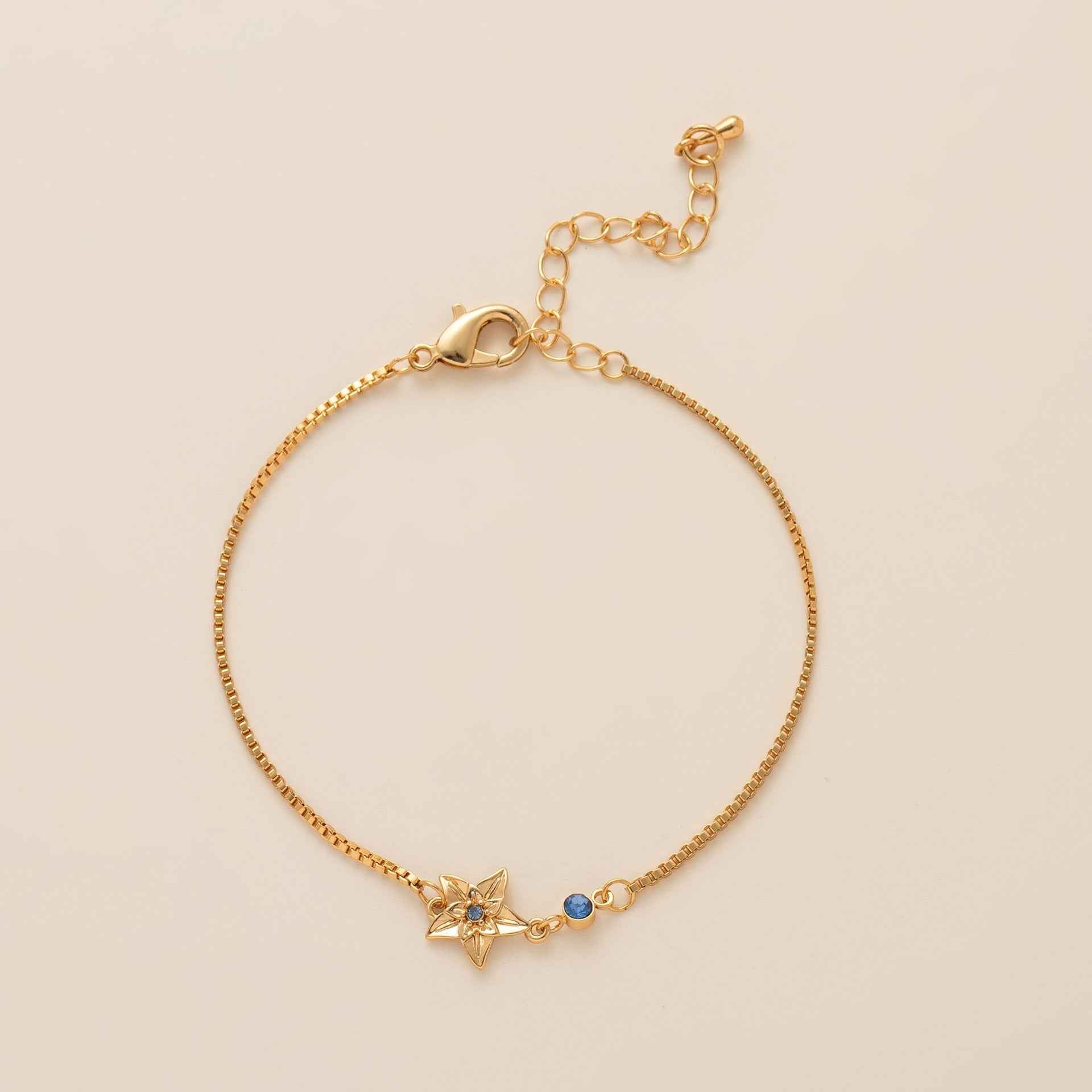 Birthstone bracelet with flower charm and cubic zirconia pendant