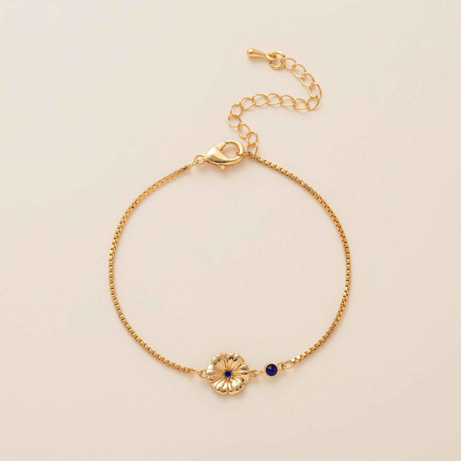 Birthstone bracelet with flower charm and cubic zirconia pendant