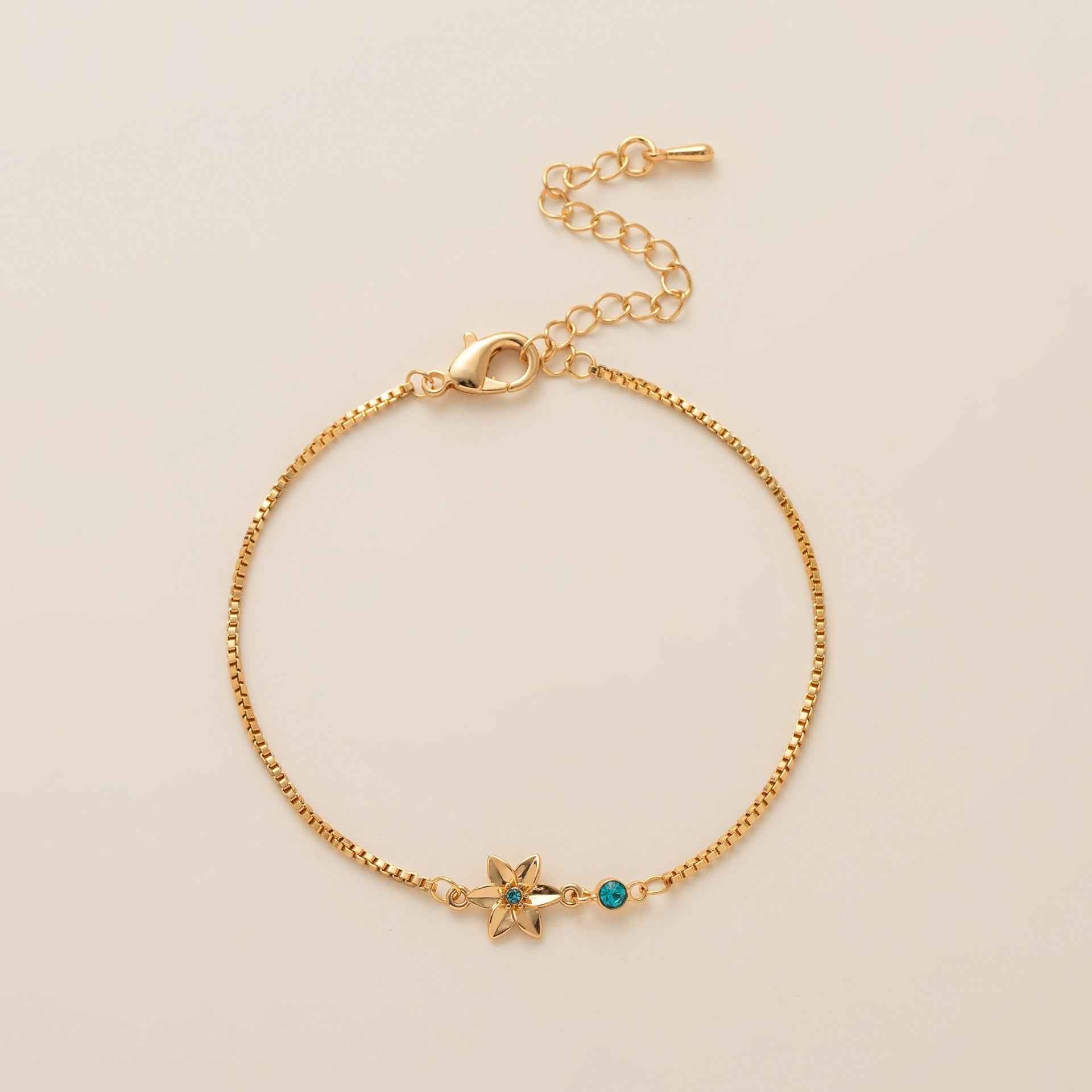 Birthstone bracelet with flower charm and cubic zirconia pendant