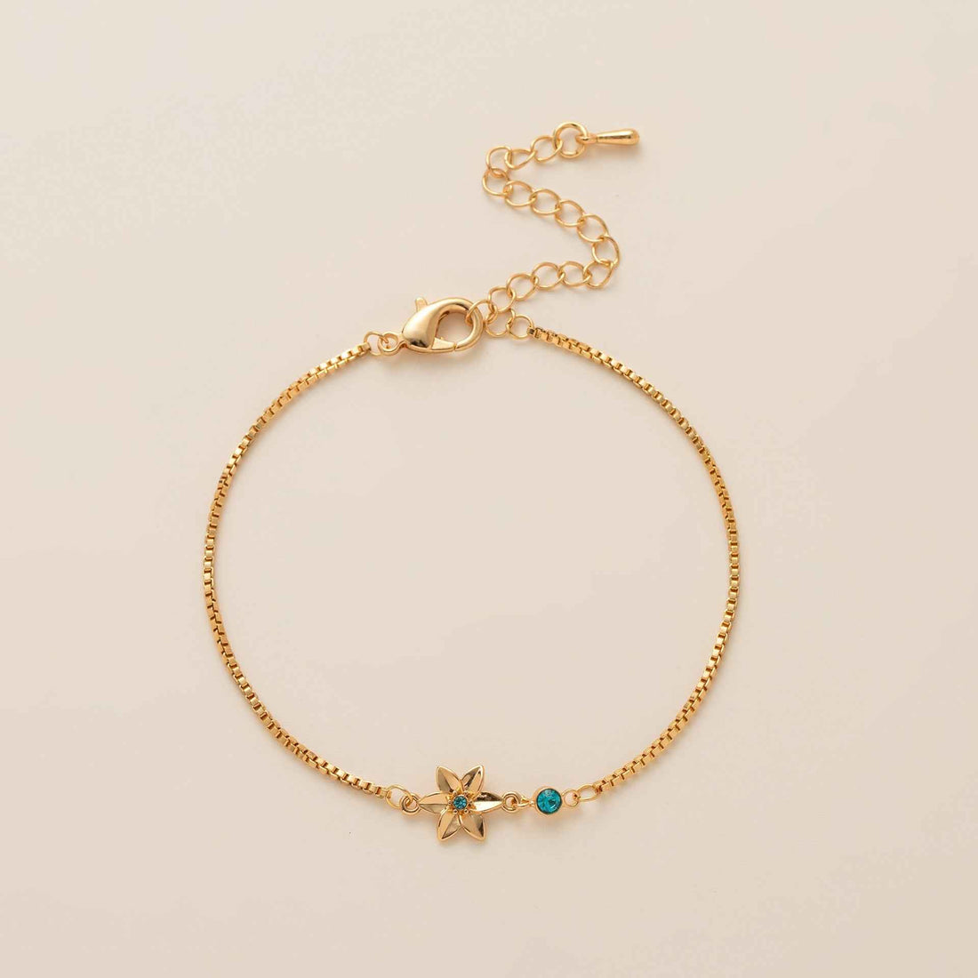 Birthstone bracelet with flower charm and cubic zirconia pendant
